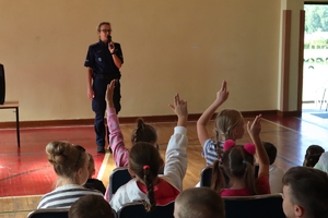 Zdjęcie przedstawia policjantkę podczas spotkania z dziećmi w szkole